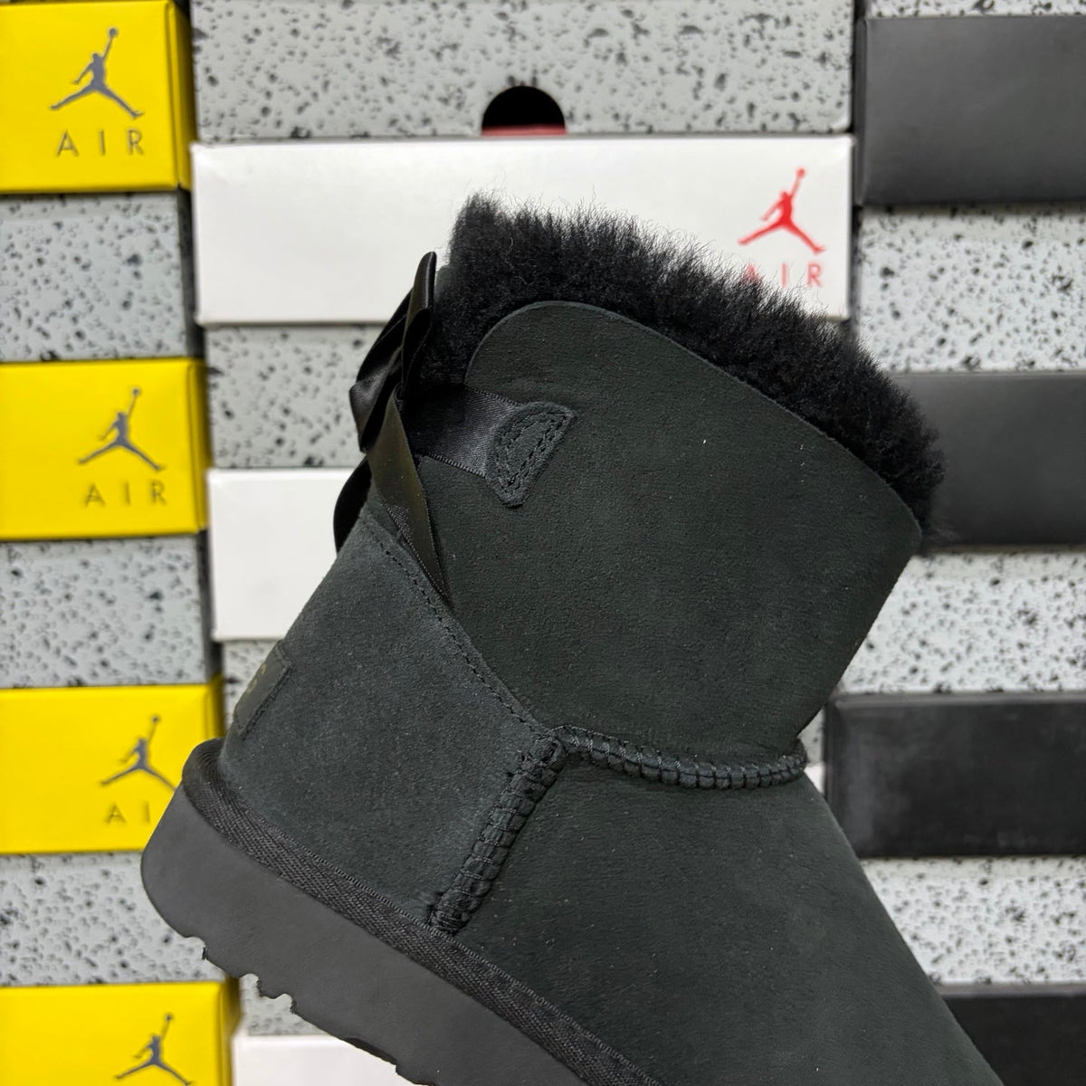 UGG Mini Bailey Bow Ankle Boot – Suede Boot with Tonal Black Shearling Lining, Black Satin Bow & All-Black Lug Sole in Black